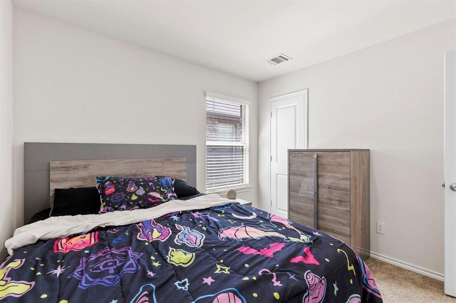 Carpeted bedroom with baseboards Carpeted bedroom with baseboards