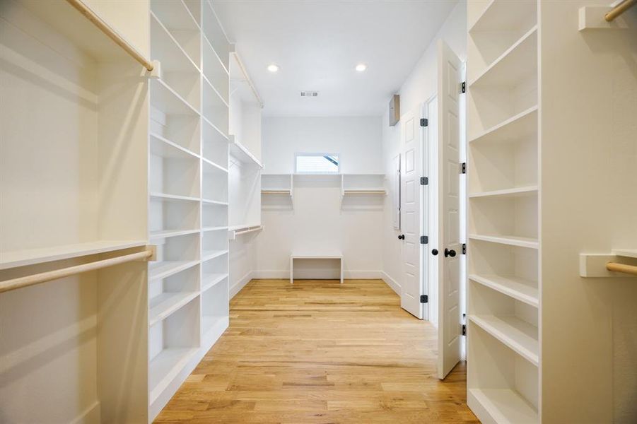 Spacious closet featuring light hardwood / wood-style flooring