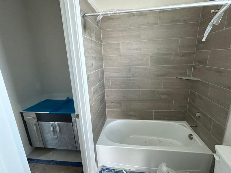 Full bath featuring shower / washtub combination and toilet