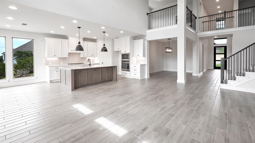 Kitchen featuring appliances with stainless steel finishes, plenty of natural light, light wood-type flooring, light countertops, and recessed lighting Kitchen featuring appliances with stainless steel finishes, plenty of natural light, light wood-type flooring, light countertops, and recessed lighting