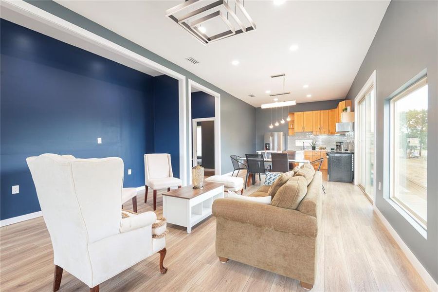 Living room featuring light wood-style flooring and recessed lighting Living room featuring light wood-style flooring and recessed lighting