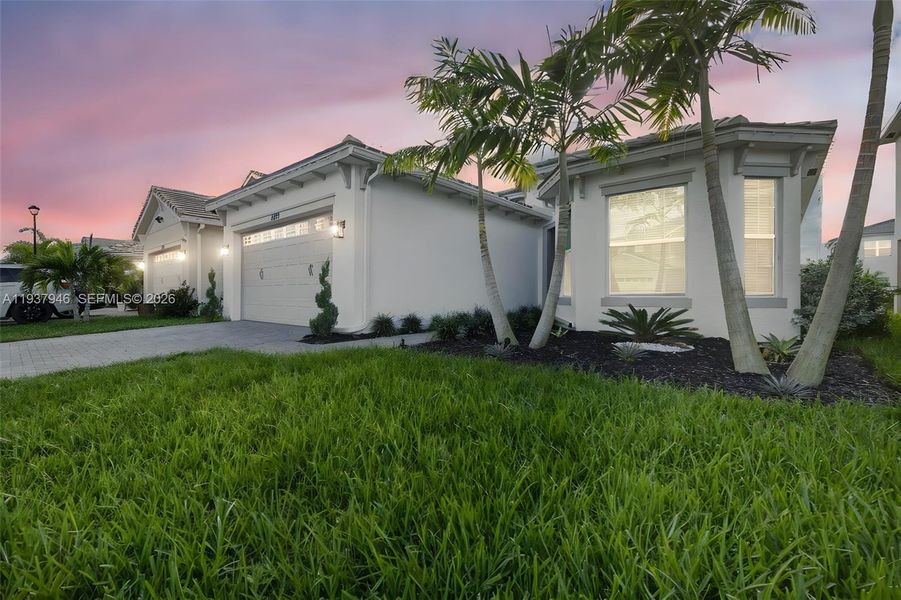 Front exterior of a new home in , Loxahatchee, FL, highlighting curb appeal (Image 1). Front exterior of a new home in , Loxahatchee, FL, highlighting curb appeal (Image 1).