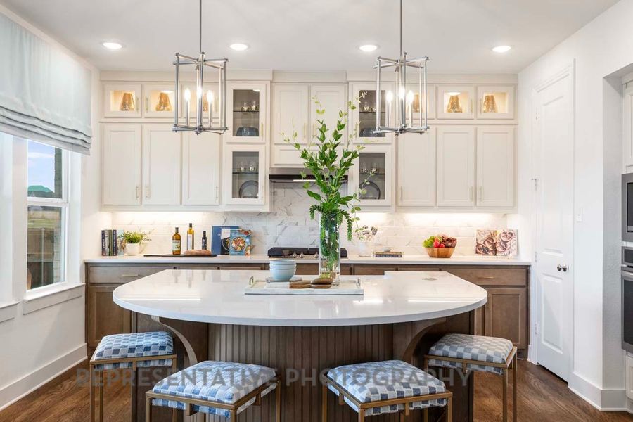 Kitchen featuring a chandelier, light countertops, a breakfast bar area, dark wood-style floors, and recessed lighting Kitchen featuring a chandelier, light countertops, a breakfast bar area, dark wood-style floors, and recessed lighting