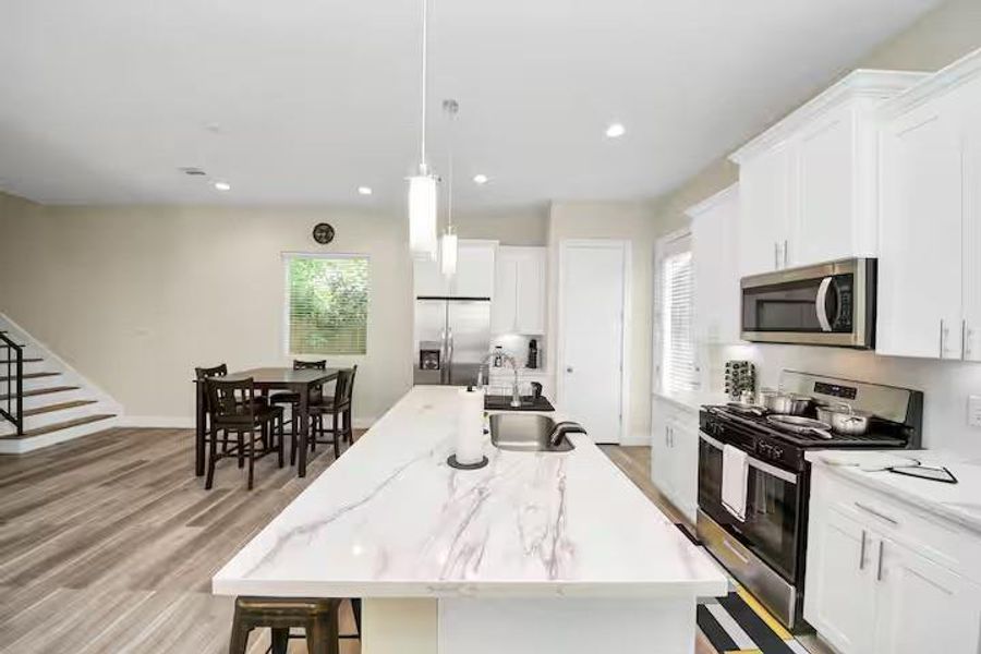 Generous counter space on both sides of the kitchen gives you room to prep and cook while still staying connected to everyone in the living area.