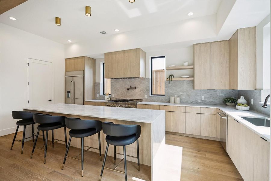 Kitchen – offers a Taj Mahal double waterfall-edge seating island and stainless steel appliance package. Kitchen – offers a Taj Mahal double waterfall-edge seating island and stainless steel appliance package.