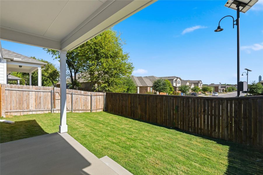 Fenced backyard featuring a patio area and a residential view