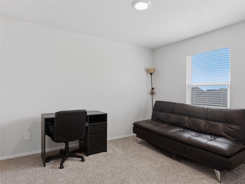 Plush carpeting and a bright window create a versatile, inviting room. Plush carpeting and a bright window create a versatile, inviting room.
