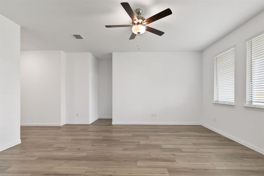 Spare room featuring ceiling fan and hardwood / wood-style flooring