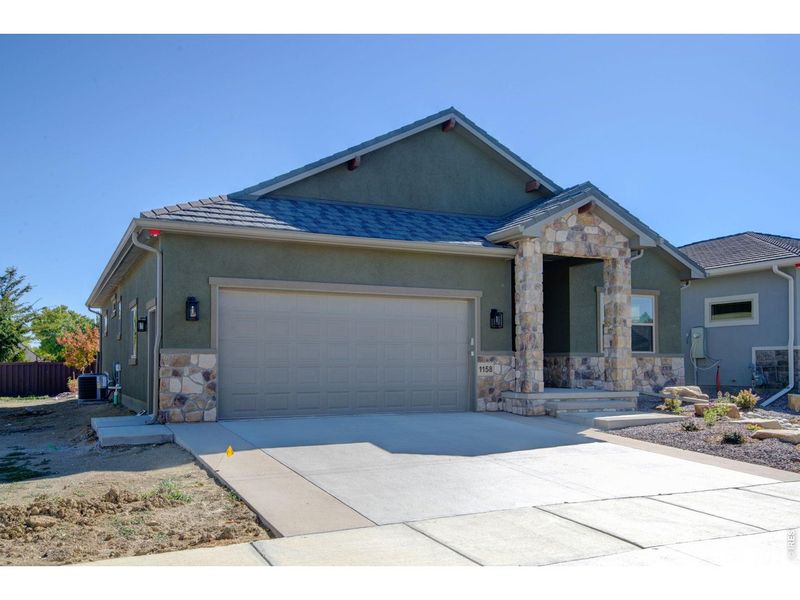 Front exterior of a new home in , Loveland, CO, highlighting curb appeal (Image 26).
