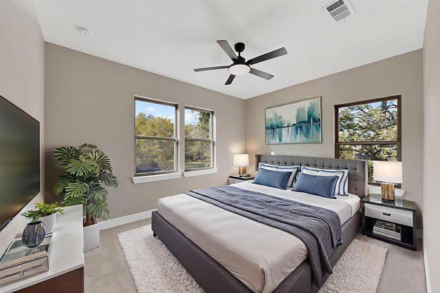 Bedroom with light carpet and a ceiling fan