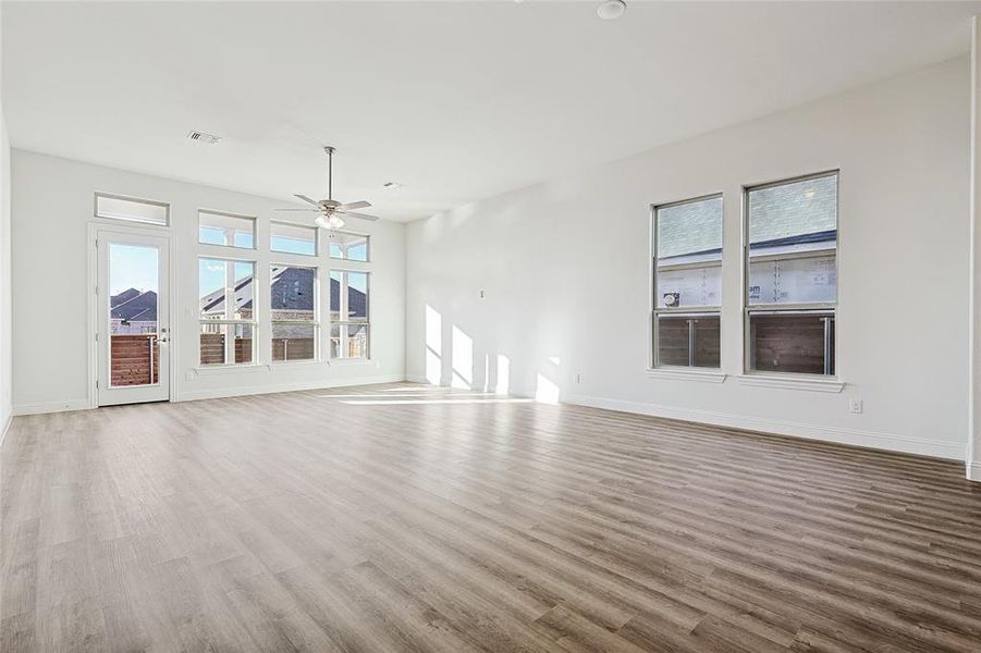 Unfurnished living room with hardwood / wood-style flooring and a healthy amount of sunlight