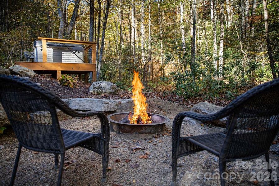 Enjoy the firepit and hot tub near the creek