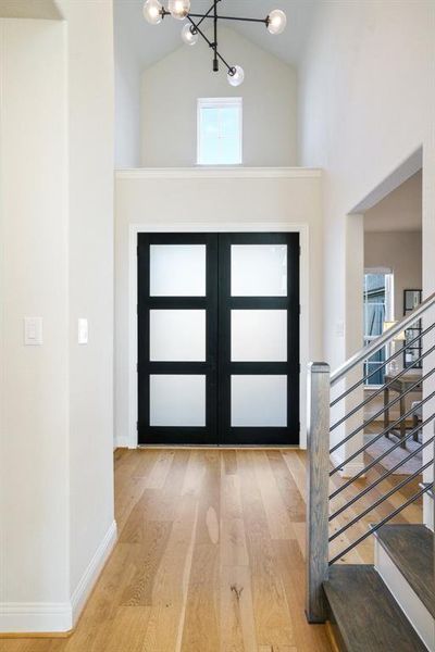 Modern Entryway Statement - Soaring ceilings, frosted glass double doors, and natural wood floors set a modern tone the moment you walk in. The open sightlines offer a glimpse of the home’s airy design and upscale finishes. Modern Entryway Statement - Soaring ceilings, frosted glass double doors, and natural wood floors set a modern tone the moment you walk in. The open sightlines offer a glimpse of the home’s airy design and upscale finishes.