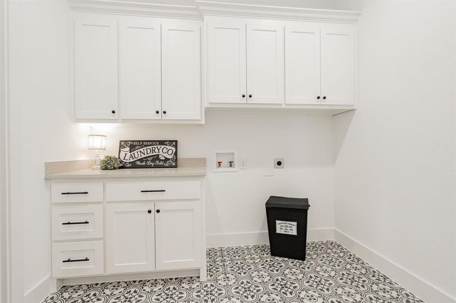 Laundry Room area featuring light tile patterned flooring, hookup for an electric dryer, washer hookup, and cabinets