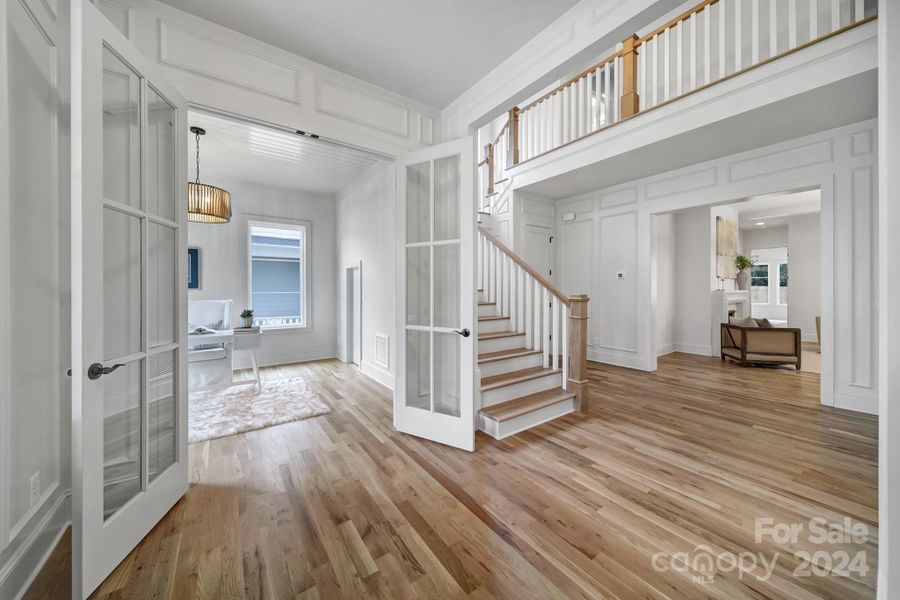 Walk into a large foyer, home office to the left and living room straight ahead.