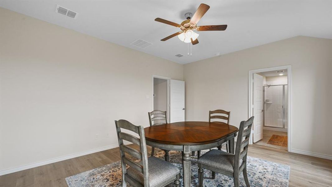 Dining room featuring light wood-style floors and a ceiling fan Dining room featuring light wood-style floors and a ceiling fan