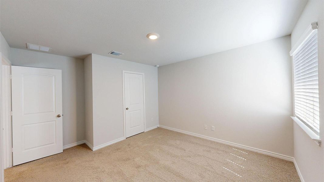The room features light beige carpet, light-colored walls, and white trim