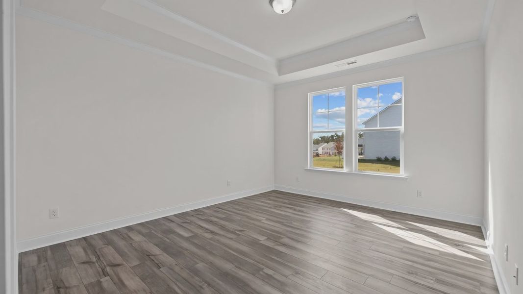 Fairfield design dining with raised tray ceiling large windows, and premium finishes at Lakeside Glen by DRB Homes, York, SC