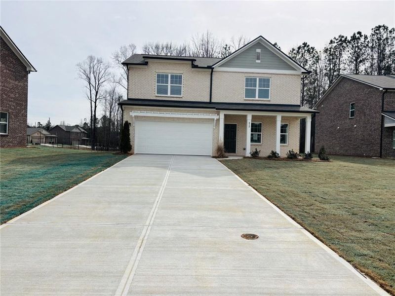 Front exterior of a new home in Kendall Grove, McDonough, GA, highlighting curb appeal (Image 1). Front exterior of a new home in Kendall Grove, McDonough, GA, highlighting curb appeal (Image 1).