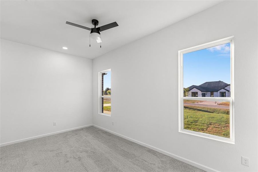 Empty room with carpet flooring, a ceiling fan, and recessed lighting