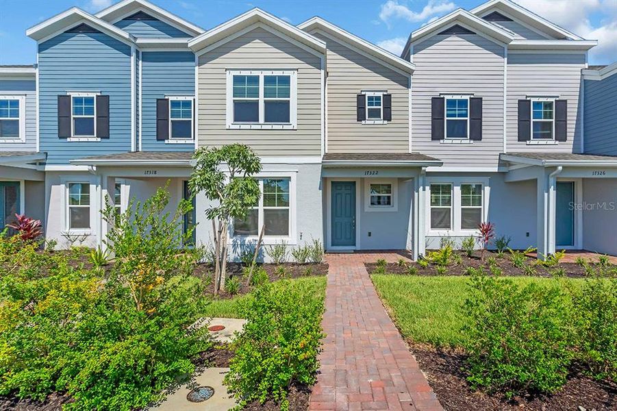 Front exterior of a new home in The Residences at Emerson Park, Apopka, FL, highlighting curb appeal (Image 1). Front exterior of a new home in The Residences at Emerson Park, Apopka, FL, highlighting curb appeal (Image 1).