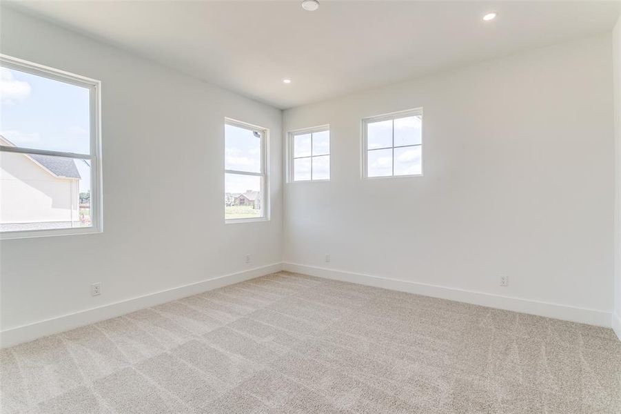 Unfurnished room with light carpet and recessed lighting Unfurnished room with light carpet and recessed lighting