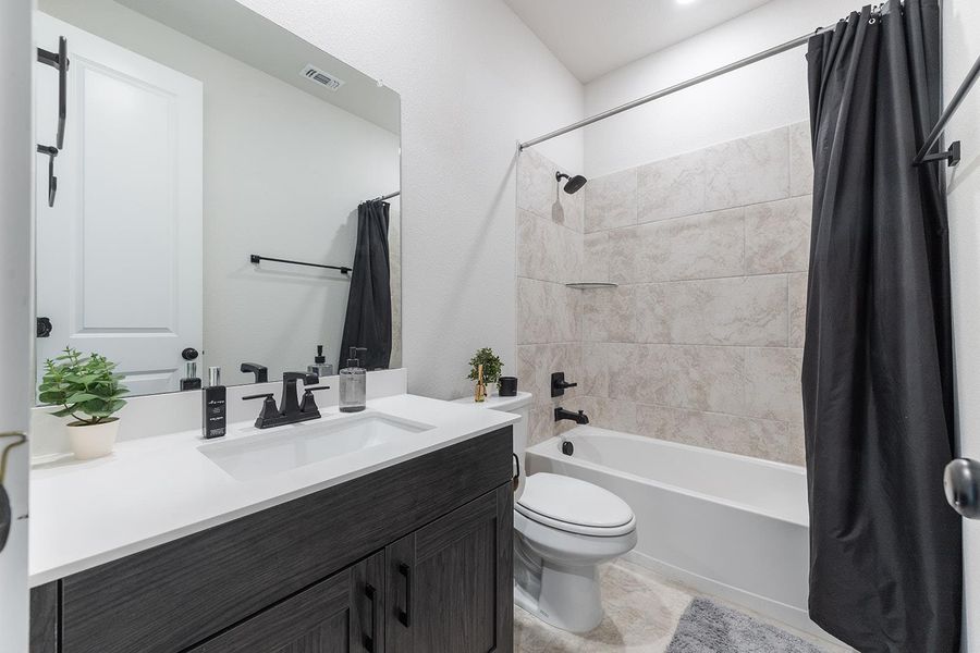 Bathroom with shower / bath combo and vanity