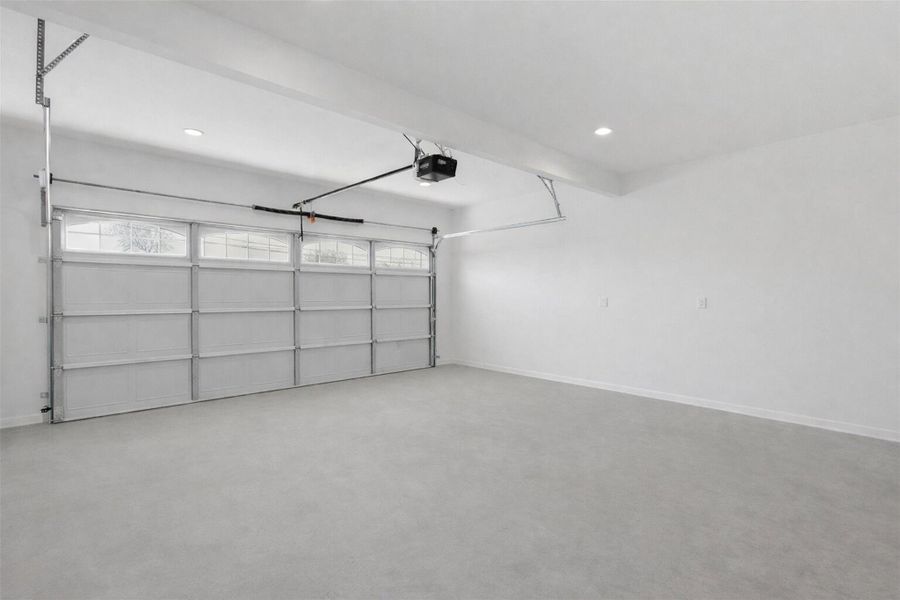 Spacious 2 car garage with garage door opener and clean flooring — move in ready.