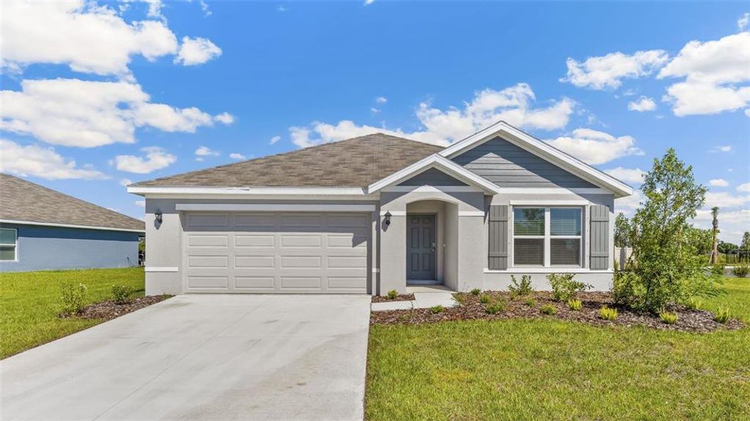 Front exterior of a new home in Mandarin Grove, Palmetto, FL, highlighting curb appeal (Image 16).