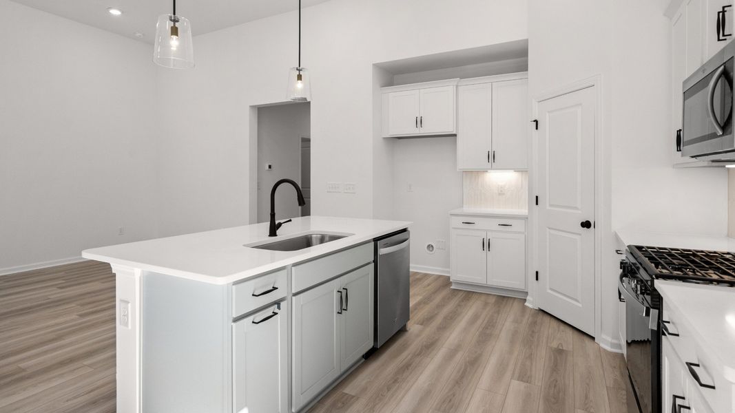 Clean, modern kitchen with ample storage and an oversized central island