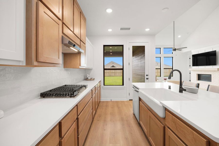 The kitchen has a beautiful view of the covered patio and a door to access.