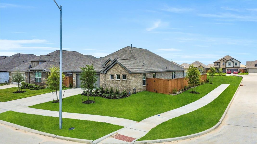 Front exterior of a new home in Sunterra, Katy, TX, highlighting curb appeal (Image 21). Front exterior of a new home in Sunterra, Katy, TX, highlighting curb appeal (Image 21).