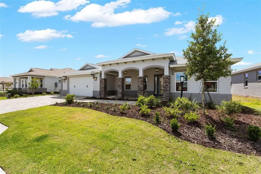 Front exterior of a new home in , Ocala, FL, highlighting curb appeal (Image 1). Front exterior of a new home in , Ocala, FL, highlighting curb appeal (Image 1).