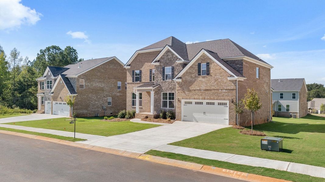 Front exterior of a new home in Heritage Pointe, Senoia, GA, highlighting curb appeal (Image 25). Front exterior of a new home in Heritage Pointe, Senoia, GA, highlighting curb appeal (Image 25).