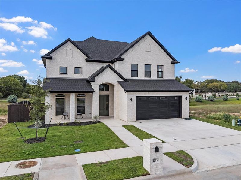 View of front of home with concrete driveway, an attached garage, a shingled roof, and a porch View of front of home with concrete driveway, an attached garage, a shingled roof, and a porch