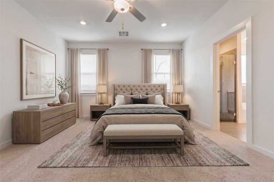Spacious primary bedroom with soft carpet, neutral walls, recessed lighting, ceiling fan, and two windows for natural light. The private en-suite bath entrance adds convenience, while the open wall space and calm color palette make the room easy to personalize as a peaceful retreat.