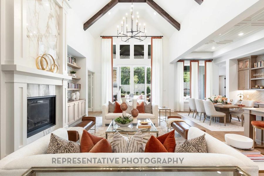 Living area featuring beamed ceiling, a chandelier, recessed lighting, high vaulted ceiling, and a fireplace Living area featuring beamed ceiling, a chandelier, recessed lighting, high vaulted ceiling, and a fireplace