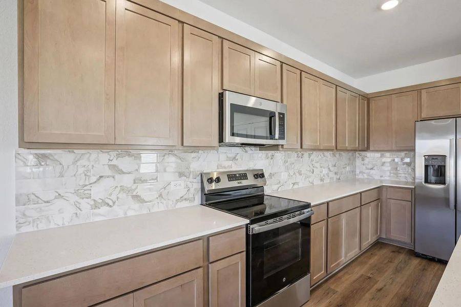 A well-appointed culinary space featuring ample cabinetry and essential appliances. A well-appointed culinary space featuring ample cabinetry and essential appliances.