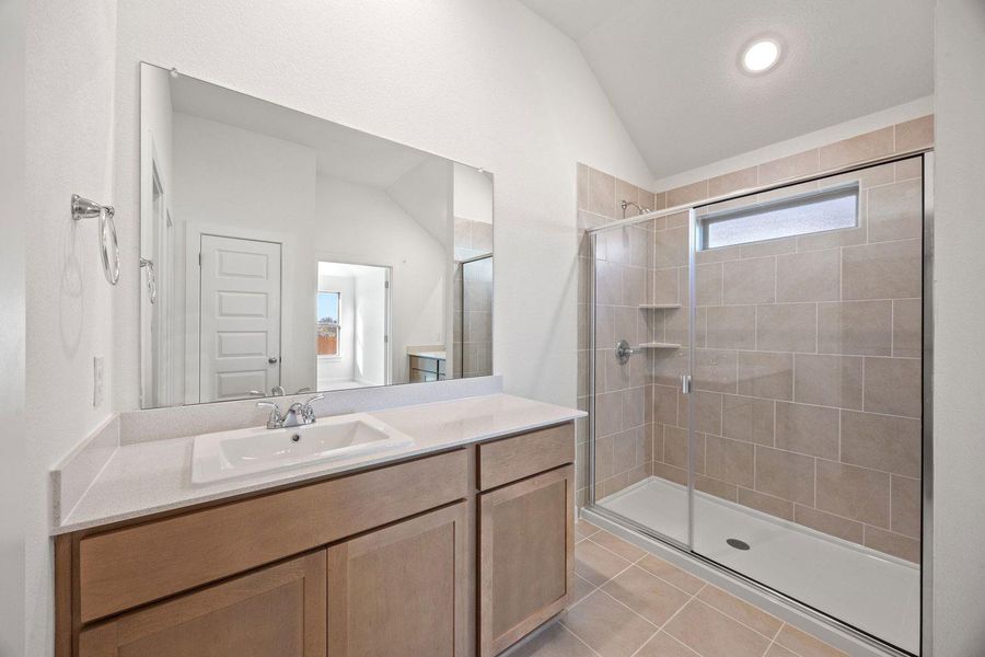 A well-appointed bathroom with a spacious vanity and a glass-enclosed walk-in shower.