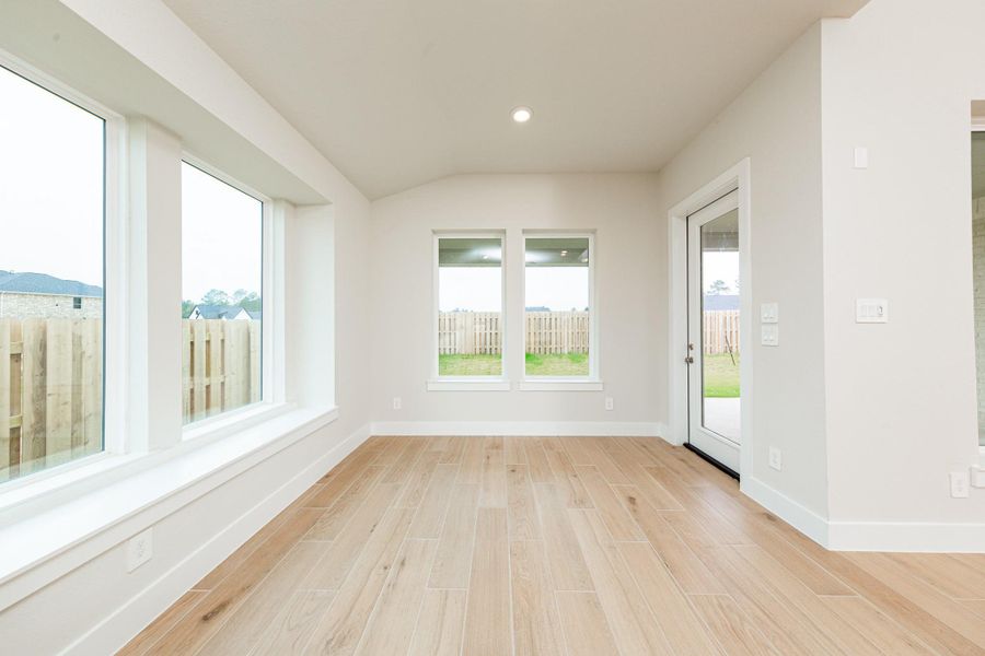 Create lasting memories around the table with family and friends in the dining! It showcases high ceilings, large windows with seating sill, tile plank flooring, and recessed lighting for a warm and welcoming atmosphere.