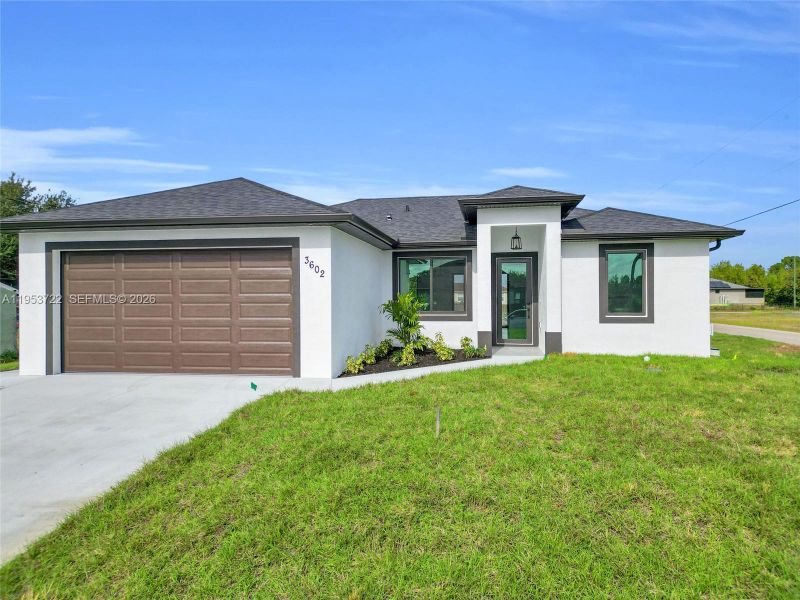 Front exterior of a new home in , Lehigh Acres, FL, highlighting curb appeal (Image 27). Front exterior of a new home in , Lehigh Acres, FL, highlighting curb appeal (Image 27).