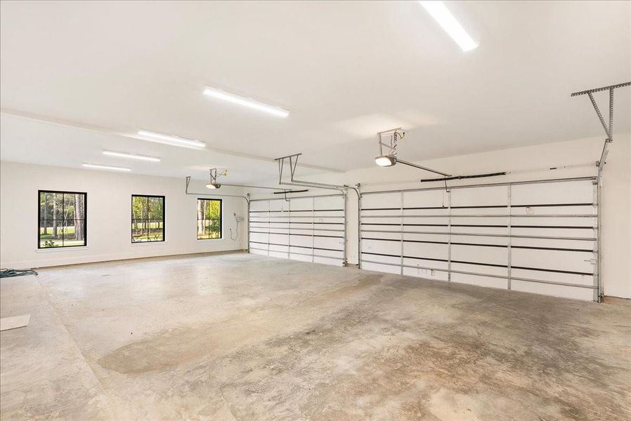 Oversized 18-foot-wide garage doors and approximately 25 feet of depth create a substantial, polished space designed to comfortably accommodate larger vehicles while adding Wi-Fi-enabled convenience, LED lighting, and estate-level functionality.