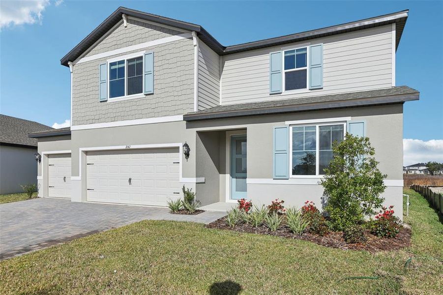 Front exterior of a new home in Two Rivers - Signature Series, Zephyrhills, FL, highlighting curb appeal (Image 2). Front exterior of a new home in Two Rivers - Signature Series, Zephyrhills, FL, highlighting curb appeal (Image 2).