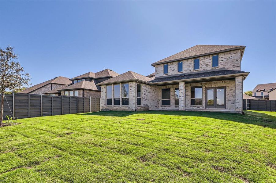 Rear view of house featuring a yard