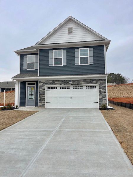 Front exterior of a new home in Springwood Grove, Central, SC, highlighting curb appeal (Image 1). Front exterior of a new home in Springwood Grove, Central, SC, highlighting curb appeal (Image 1).