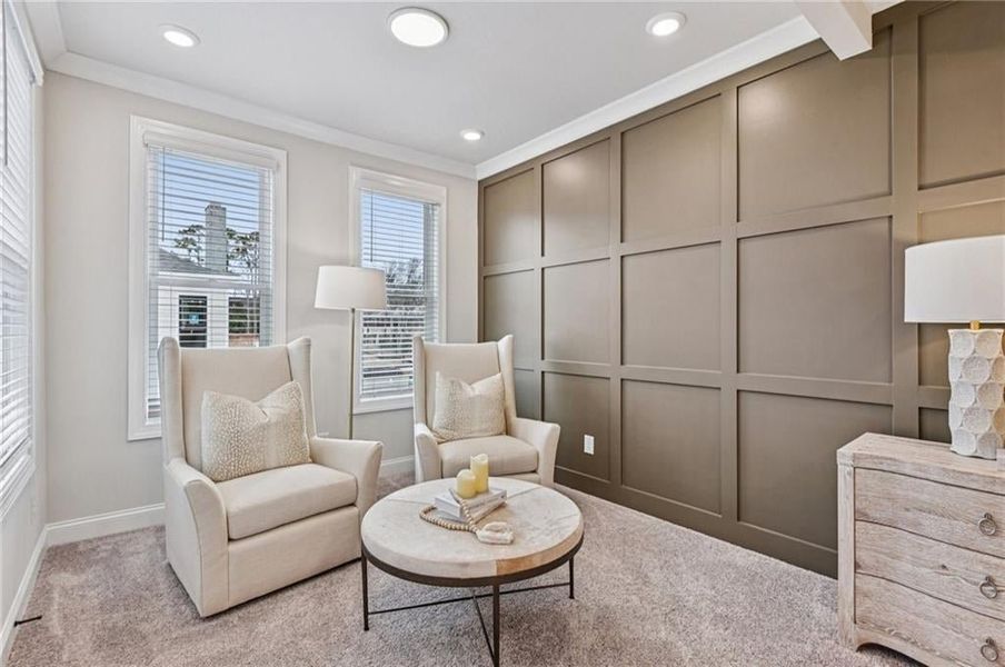Sitting room with a decorative wall, carpet flooring, crown molding, and recessed lighting