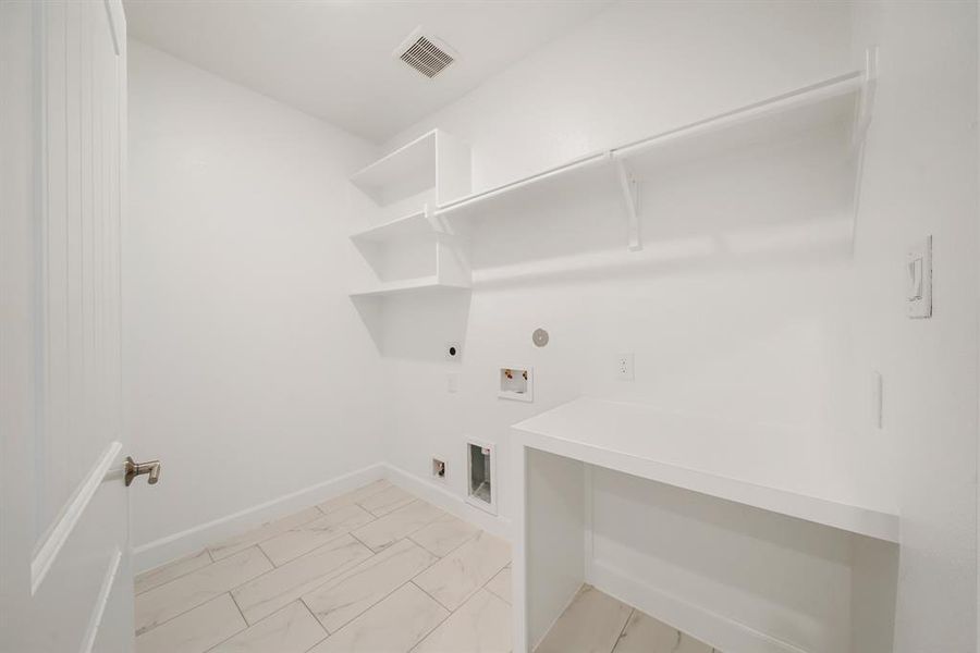 The Utility Room is located on the second floor, and features built-in shelves for additional storage. (Sample photos of a completed Lisbon floor plan. The image may feature alternative selections and/or upgrades.)