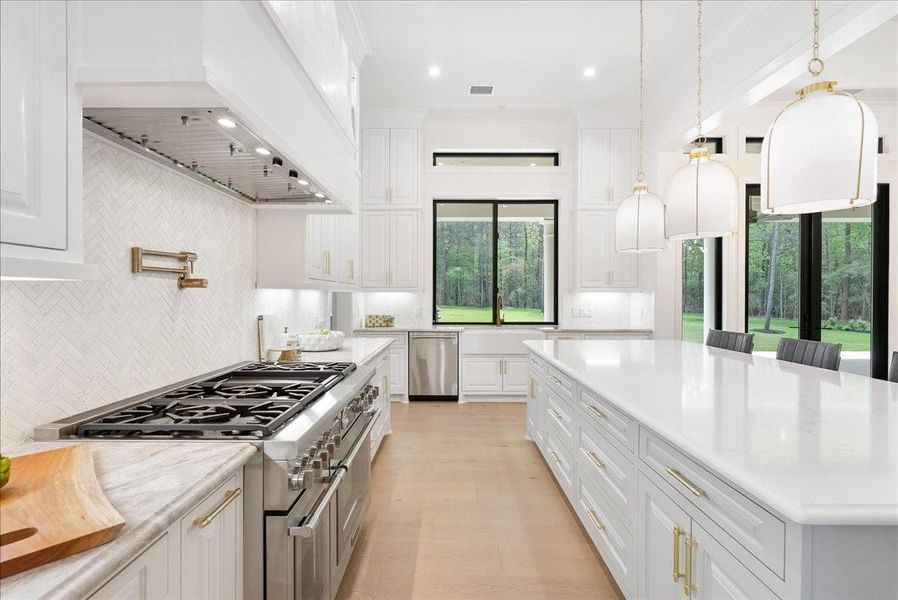 The kitchen is anchored by a 48-inch Thermador professional range with double ovens, delivering restaurant-level capability within an exquisitely designed entertaining space.