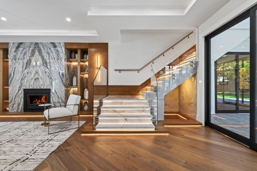Architectural details, rich hardwood flooring and the sculptural staircase create a sophisticated interior focal point.