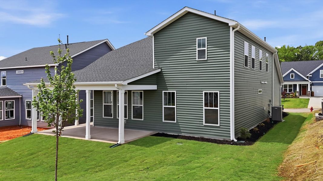 Superior curb appeal continues to the back with a refined, covered outdoor living space located at Iris Meadows